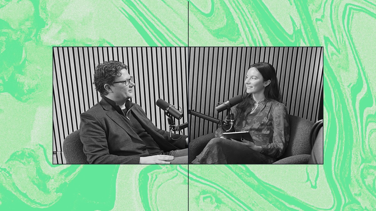 a man and woman sitting on a couch with a microphone